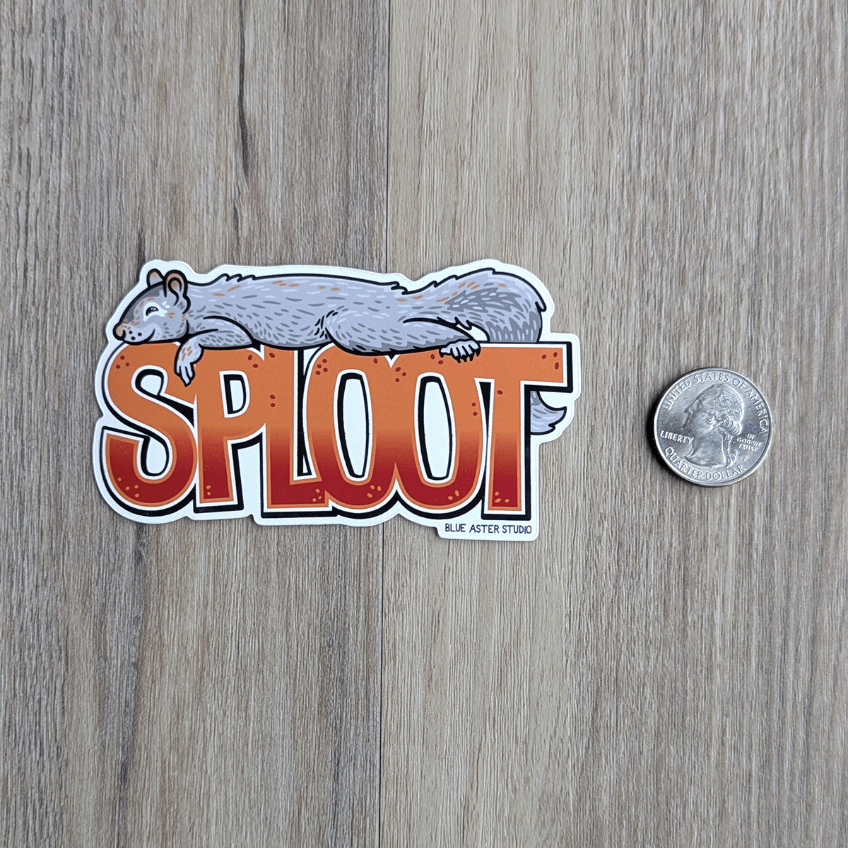 The sploot sticker with a USD quarter beside it for scale.