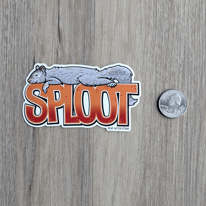 The sploot sticker with a USD quarter beside it for scale.