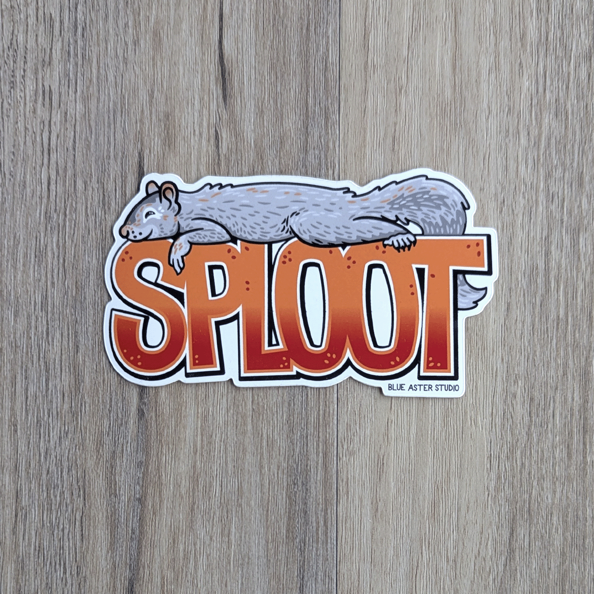 A gray squirrel lies prone on top of the word SPLOOT