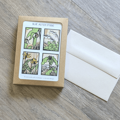 A box of spring ephemeral note cards sitting next to an example of the envelope the cards come with in the box.