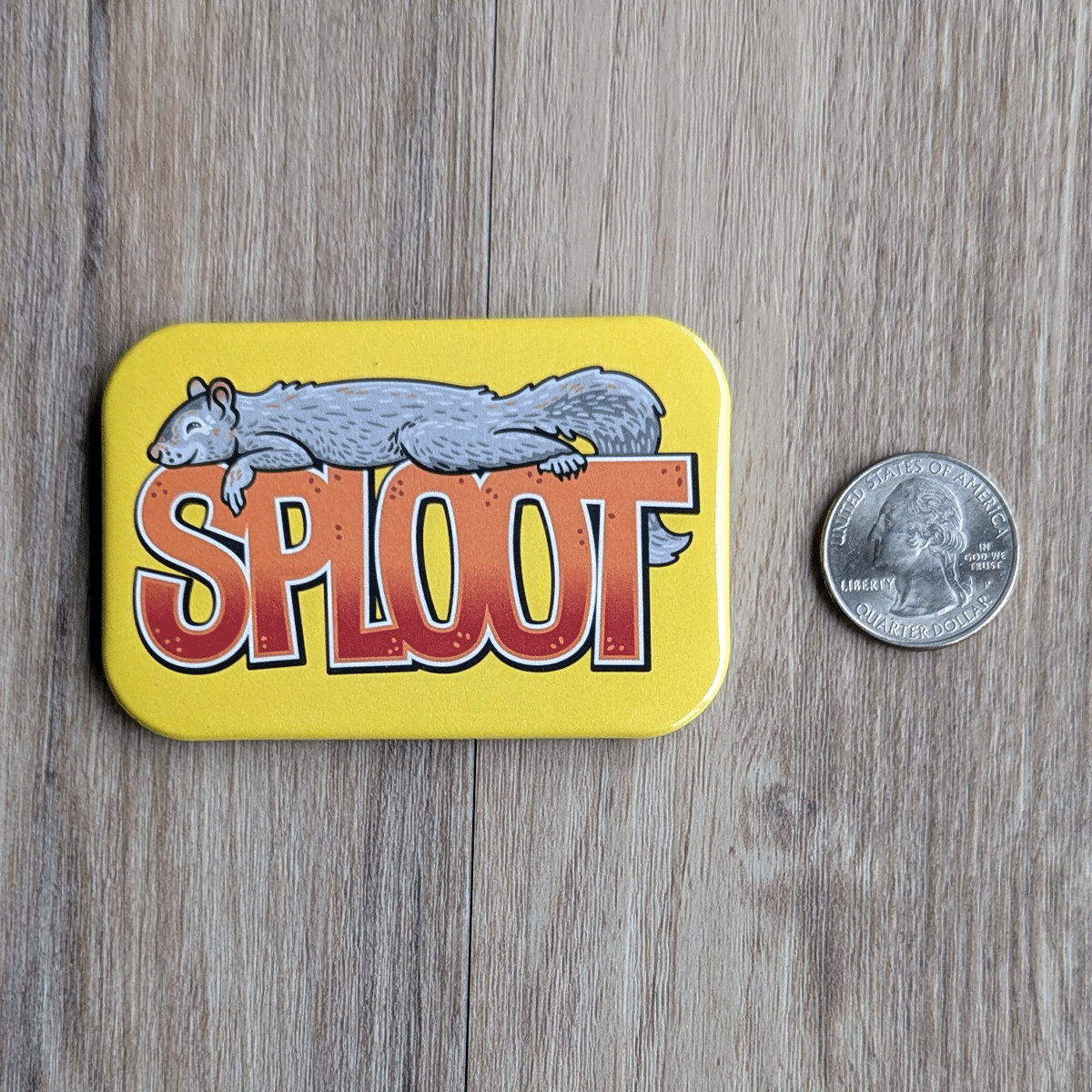 The squirrel sploot magnet next to a USD quarter for scale.