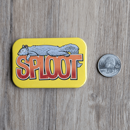 The squirrel sploot magnet next to a USD quarter for scale.
