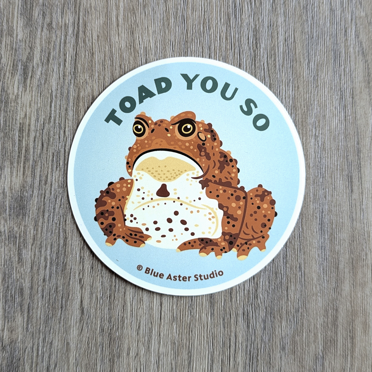 A round sticker with a toad illustration and the words Toad You So.