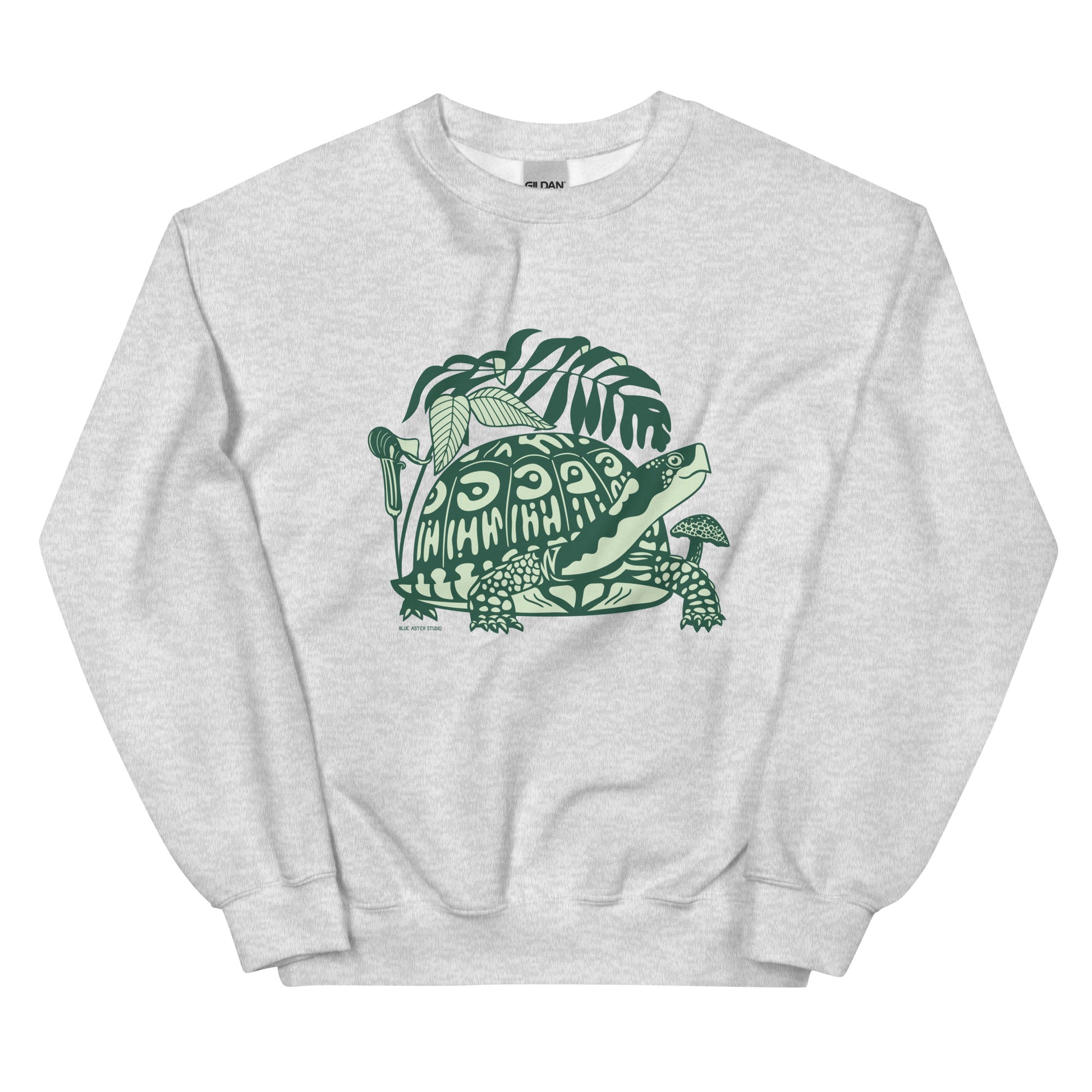 A light gray crew neck sweatshirt with a design of a box turtle surrounded by woodland plants.