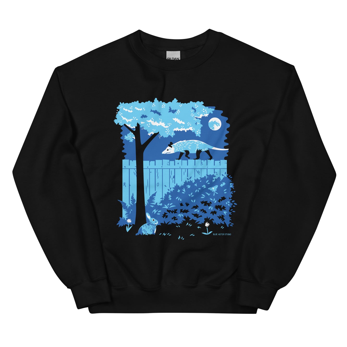 A black sweatshirt with an illustration of an opossum walking on a moonlit fence with a rabbit and a luna moth in the yard below.