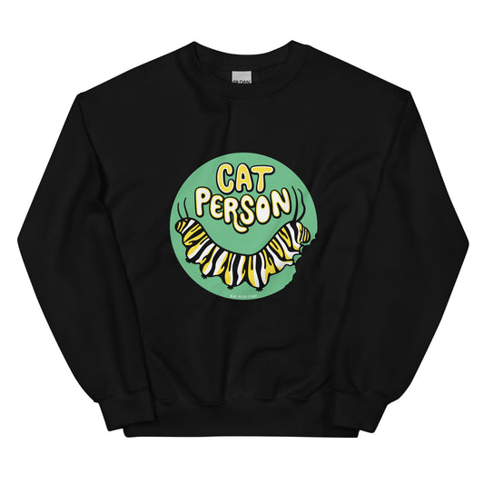 A black sweatshirt with a green circular design of the text Cat Person above a monarch caterpillar, which is munching at the circle.