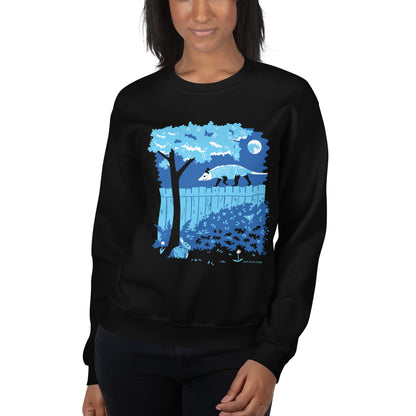 A model wearing the black sweatshirt of an illustrated opossum and bunny night time backyard.