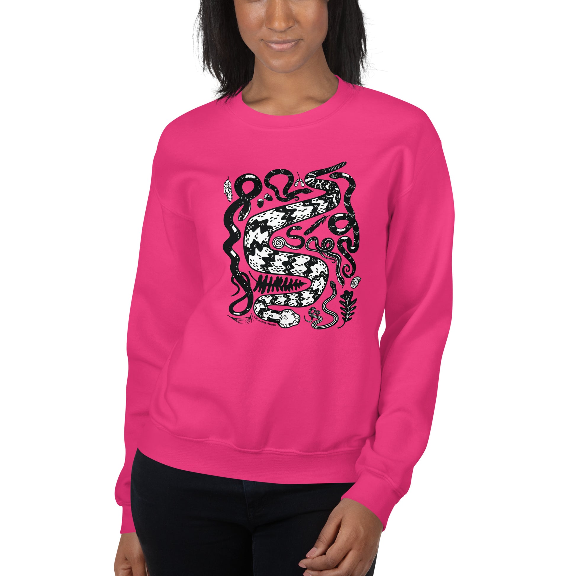 A woman modeling the pink seven snakes sweatshirt.