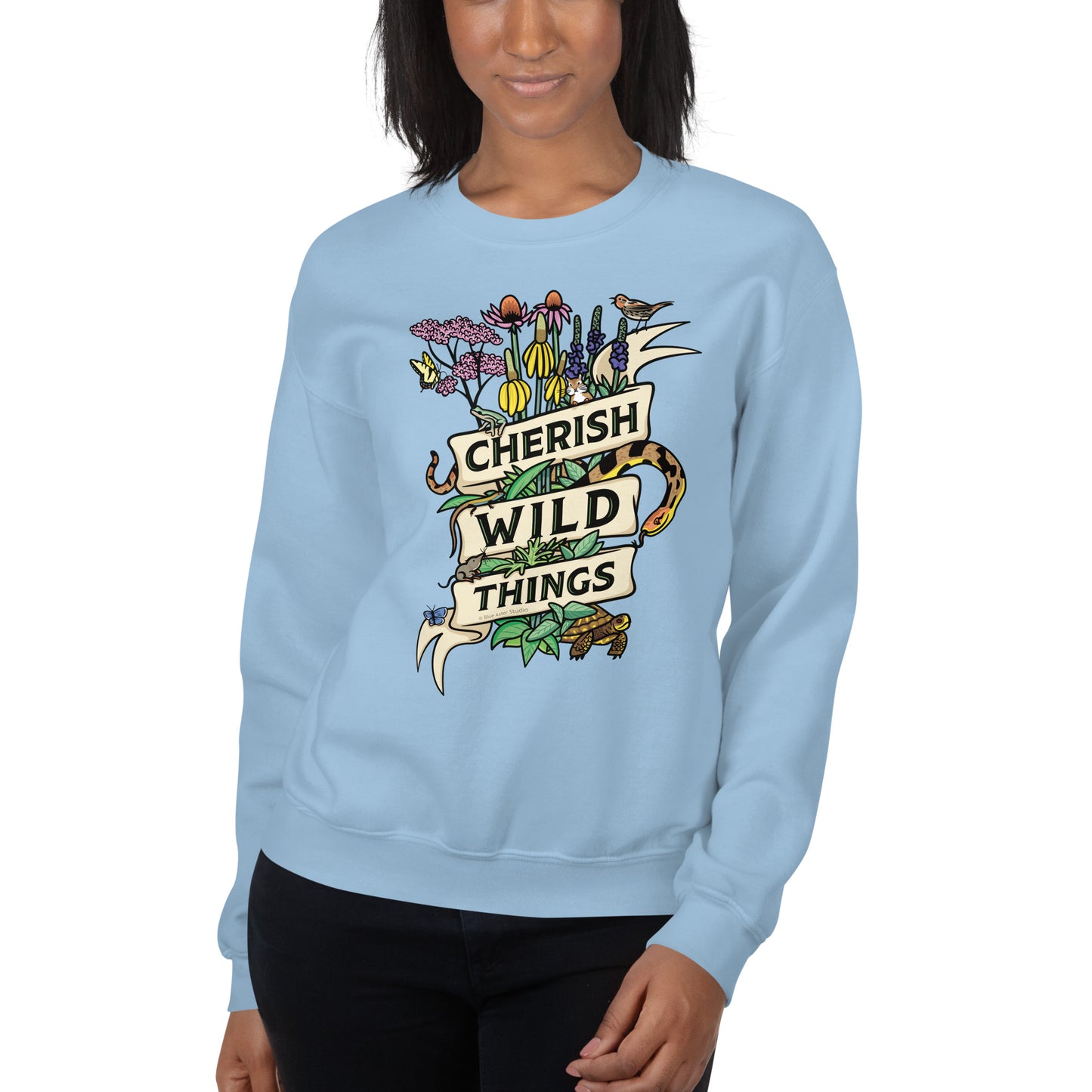 A model wearing a light blue Cherish Wild Things sweatshirt.