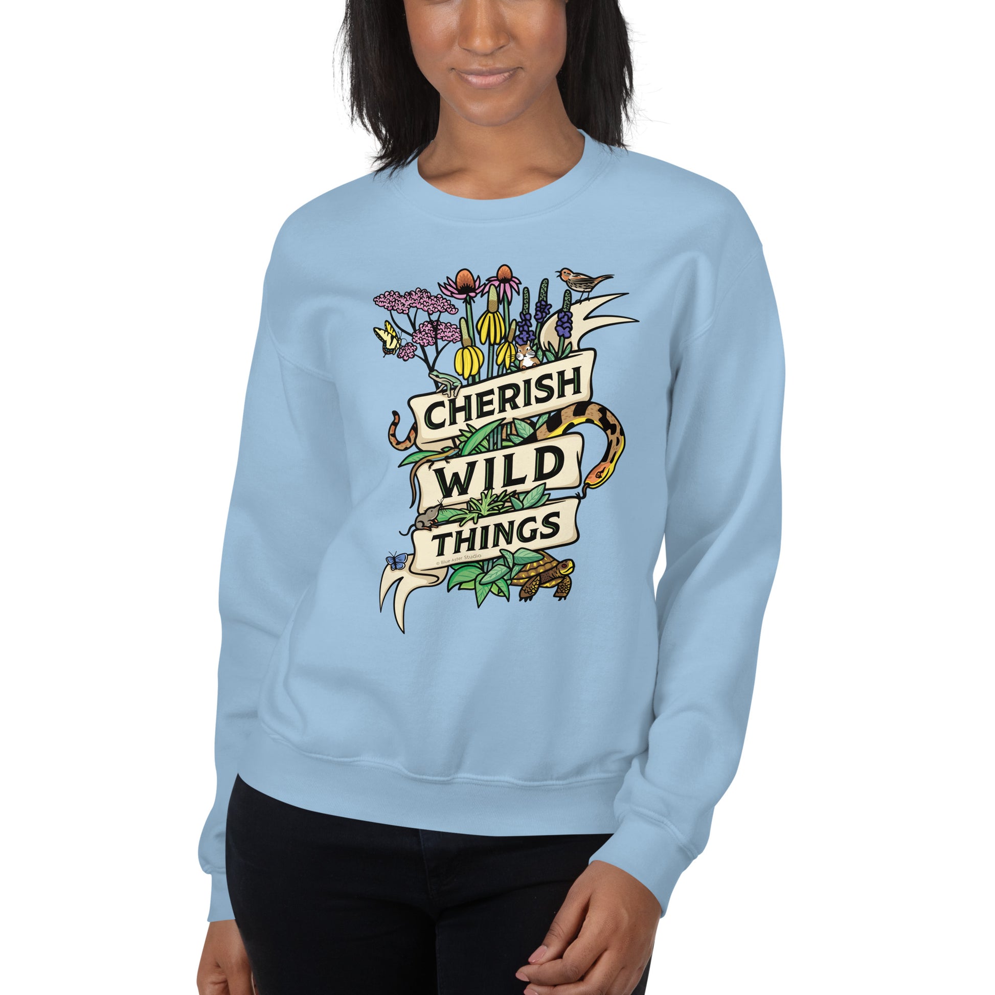 A model wearing a light blue Cherish Wild Things sweatshirt.