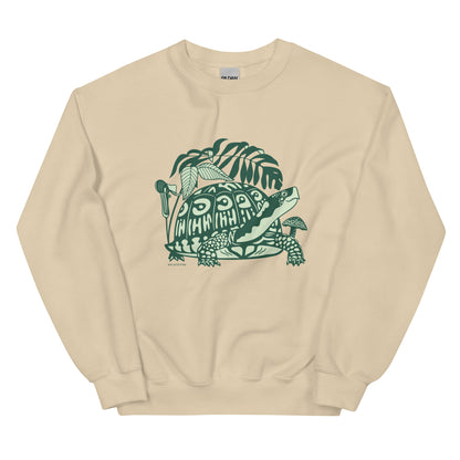A light beige crew neck sweatshirt with a design of a box turtle surrounded by woodland plants.