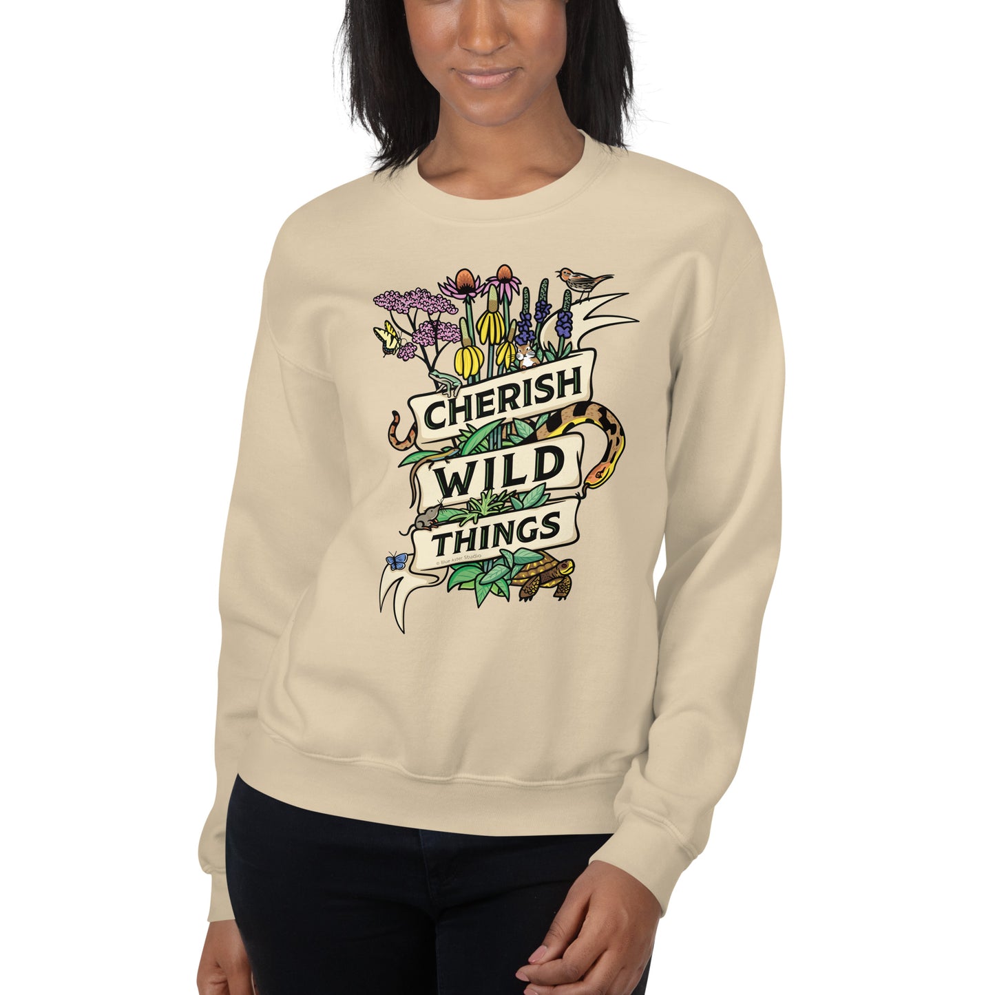 A model wearing a tan Cherish Wild Things sweatshirt.