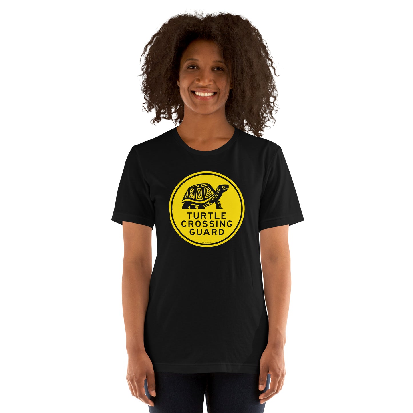 A woman wearing the turtle crossing guard short-sleeved tee.