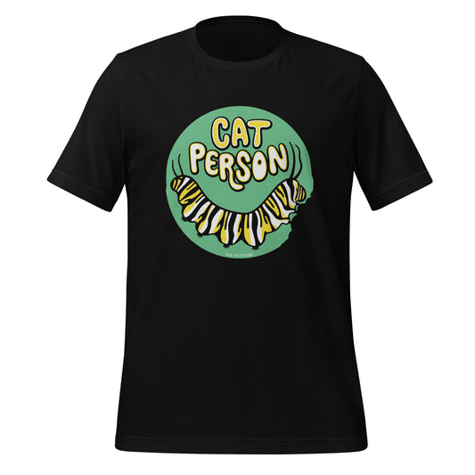 A black t-shirt with a green circular design of the text Cat Person above a monarch caterpillar, which is munching at the circle.