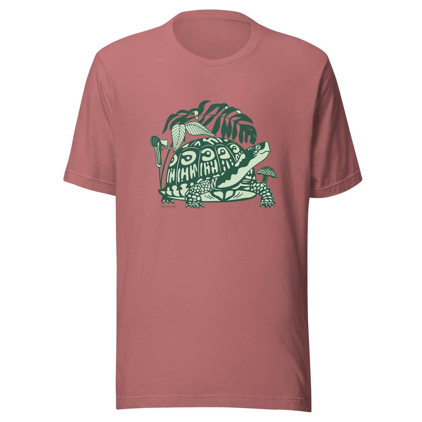 A mauve t-shirt with a front design of a box turtle surrounded by North American native woodland plants.