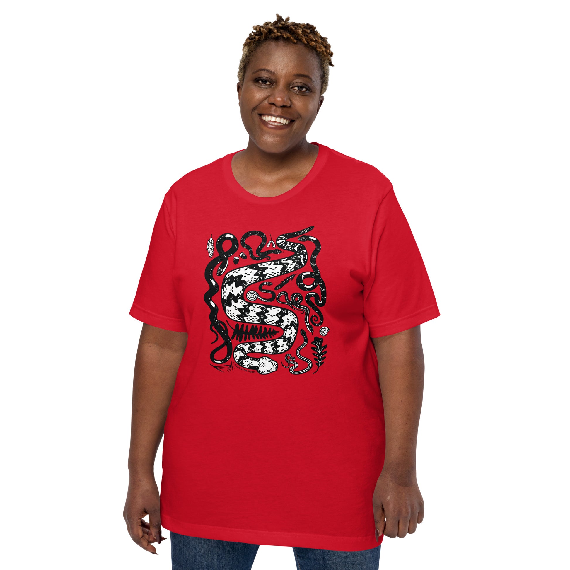 A woman modeling the unisex seven snakes short-sleeved t-shirt in red.