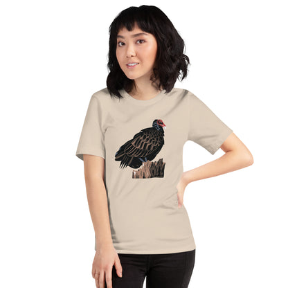 A woman wearing the cream colored majestic turkey vulture short-sleeved t-shirt.