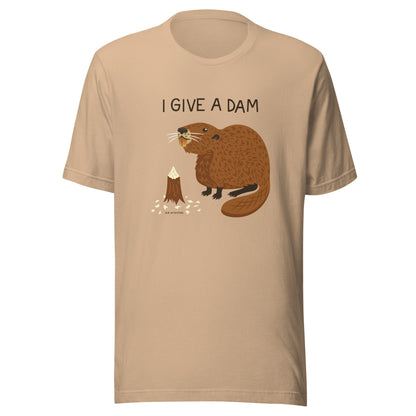 A tan unisex t-shirt with an illustration of a beaver and the words I Give A Dam printed on the front.
