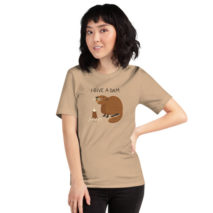 A woman modeling the unisex I Give A Dam beaver t-shirt in tan.