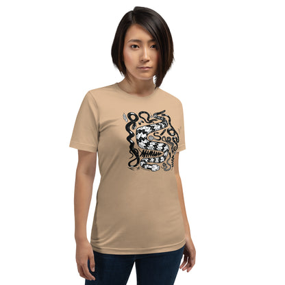 A woman showing off the seven snakes short-sleeved unisex t-shirt in tan.