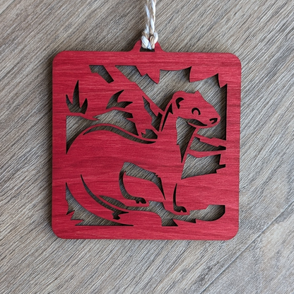 A red wooden laser cut long-tailed weasel ornament.