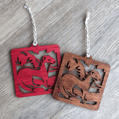 A red and a brown wooden laser cut long-tailed weasel ornament.