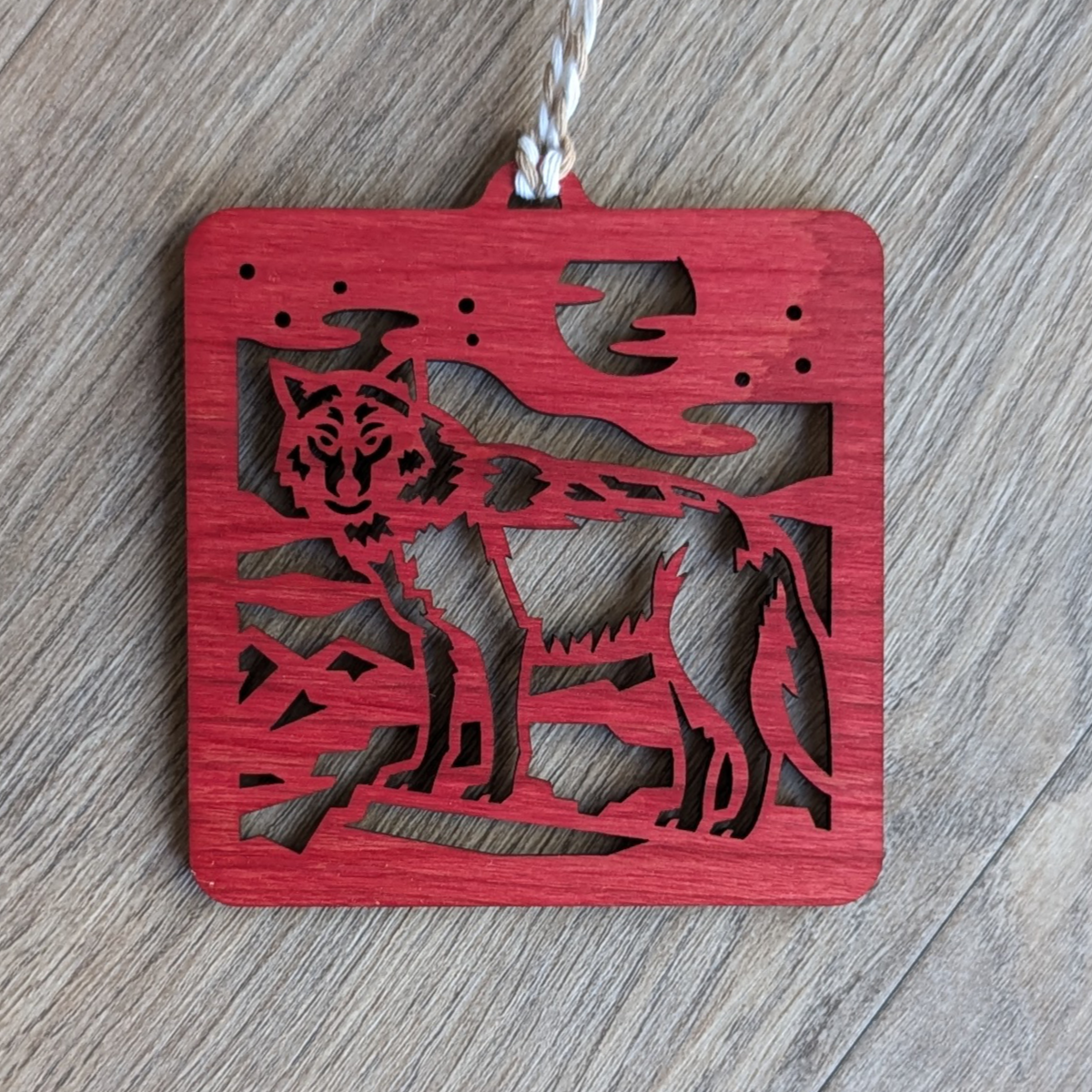 A red wooden laser cut wolf ornament.