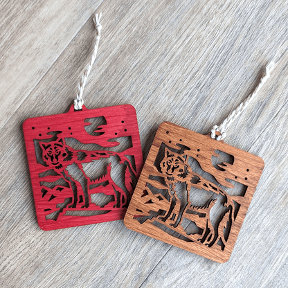 A red and a brown wooden laser cut wolf ornament.