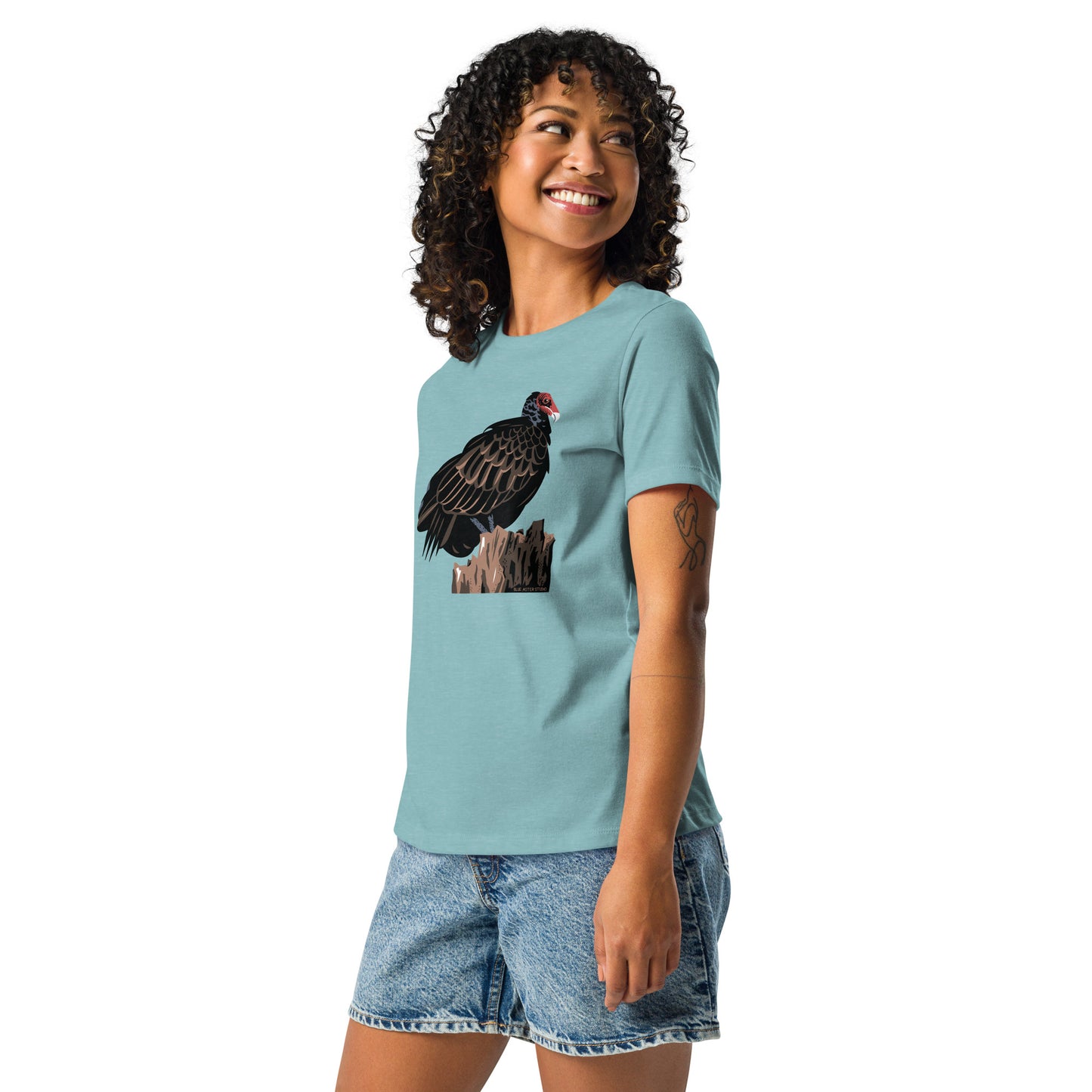 A model wearing the women's cut blue majestic turkey vulture short-sleeved shirt.