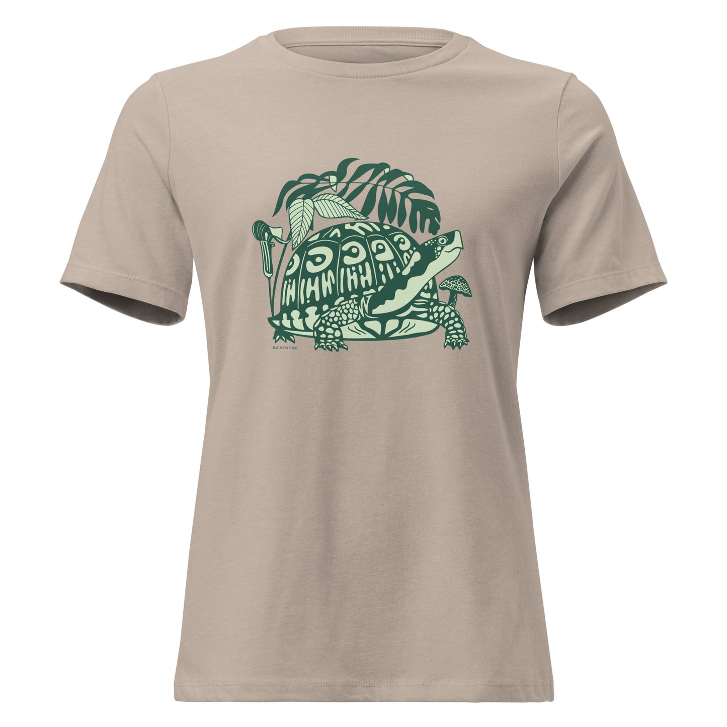 Heather tan colored ladies t-shirt with a design of a box turtle surrounded by North American woodland plants.