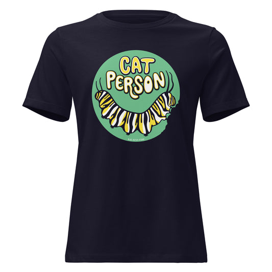 A black t-shirt with a green circular design of the text Cat Person above a monarch caterpillar, which is munching at the circle.