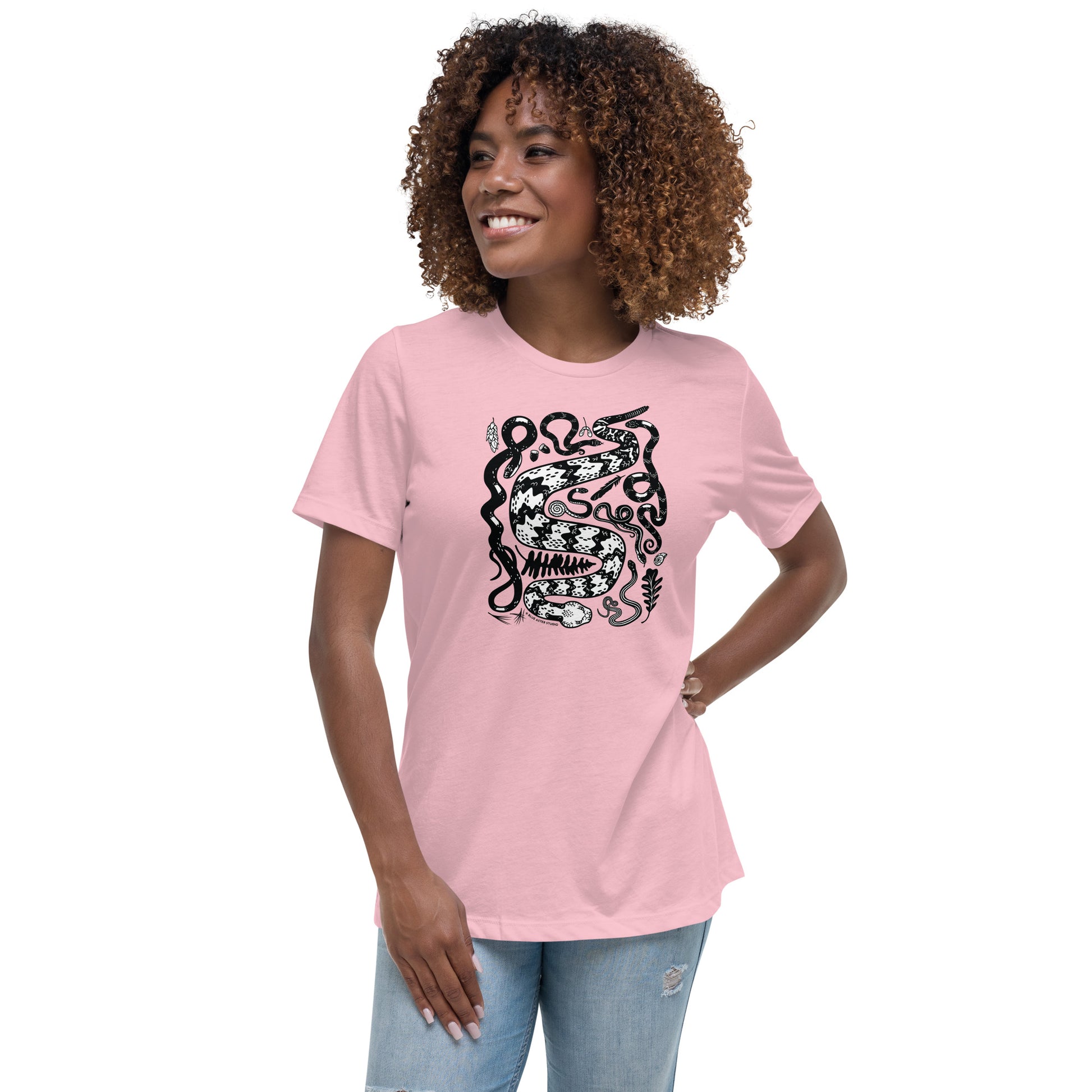 A woman wearing the women's relaxed cut seven snakes tee in pink.