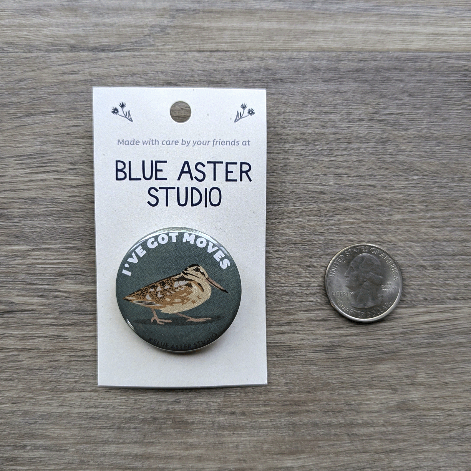 The woodcock button sitting next to a USD quarter to show scale.