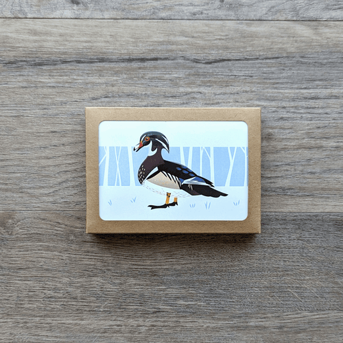 A box of eight notecards featuring an illustration of a male woodduck. Cards are blank on the inside and come with envelopes. 