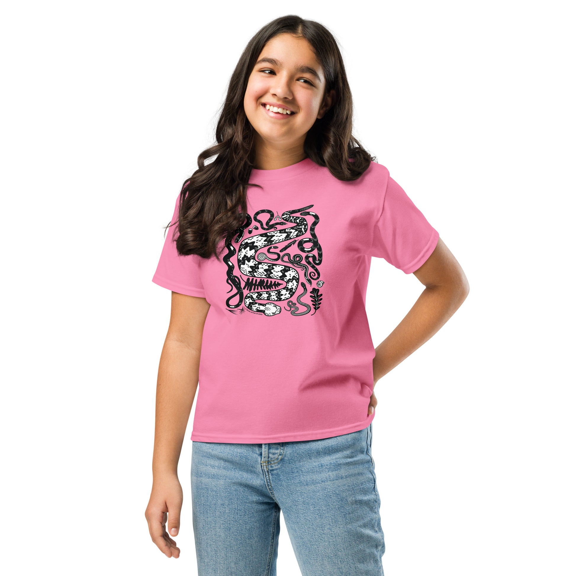 A young girl wearing a pink seven snakes t-shirt.