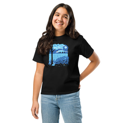 A young girl wears the opossum and rabbit t-shirt in black.