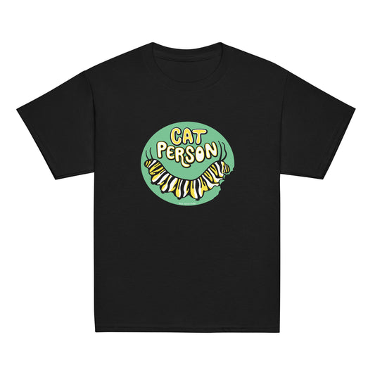 A youth sized black t-shirt with a green circular design of the text Cat Person above a monarch caterpillar, which is munching at the circle.