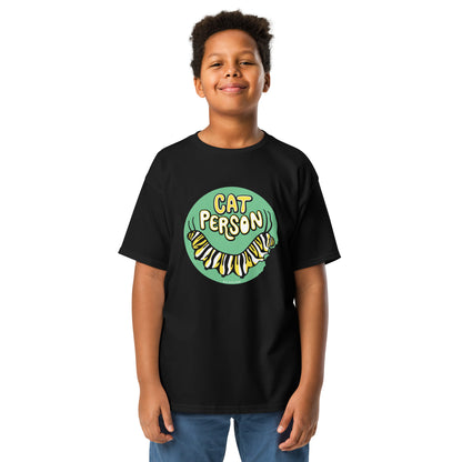 A young boy wearing the cat person monarch butterfly caterpillar tee.