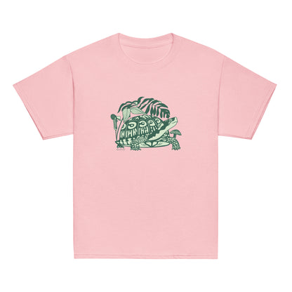 A pink youth-sized t-shirt with a design of a happy box turtle surrounded by native North American woodland plants.