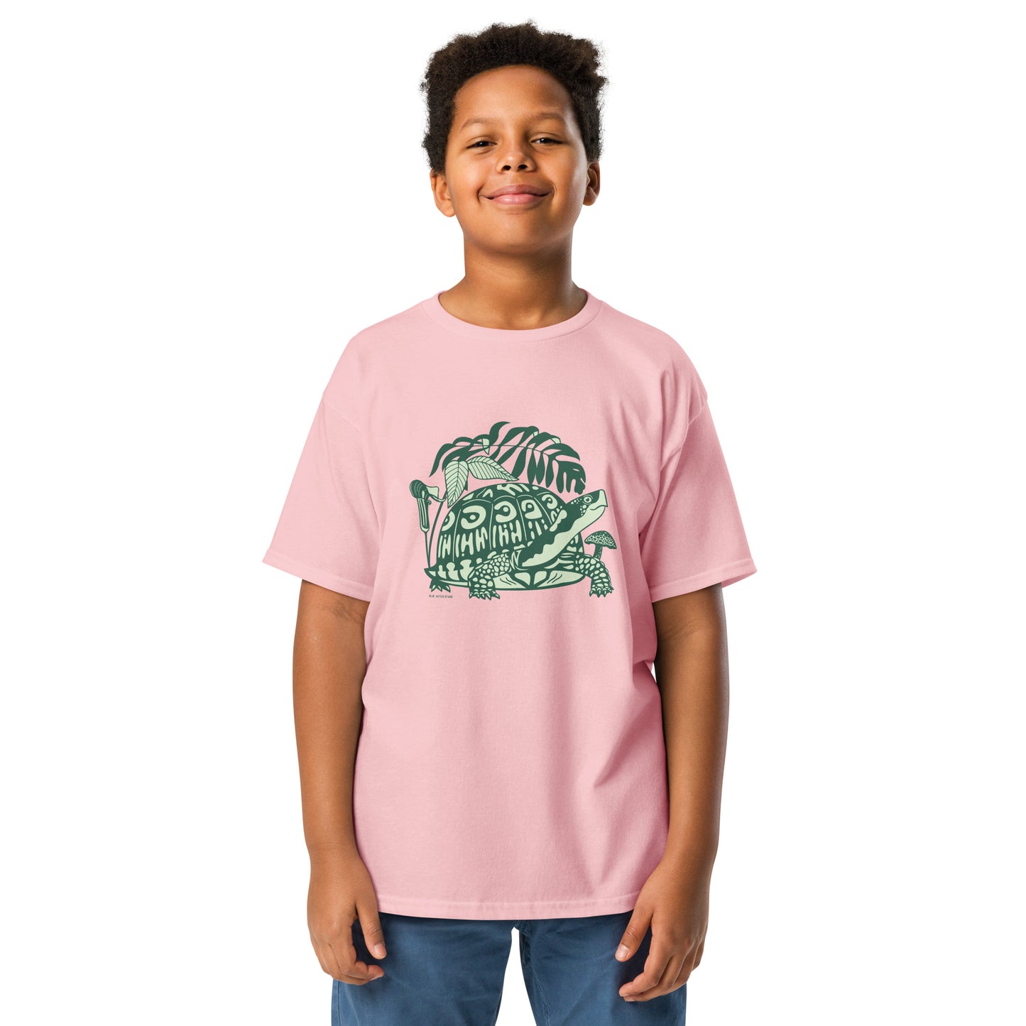 A boy modeling the pink youth sized box turtle tee.