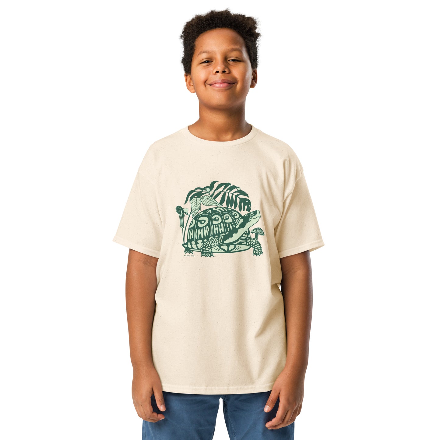 A boy modeling an off-white tee with a box turtle design on the front.