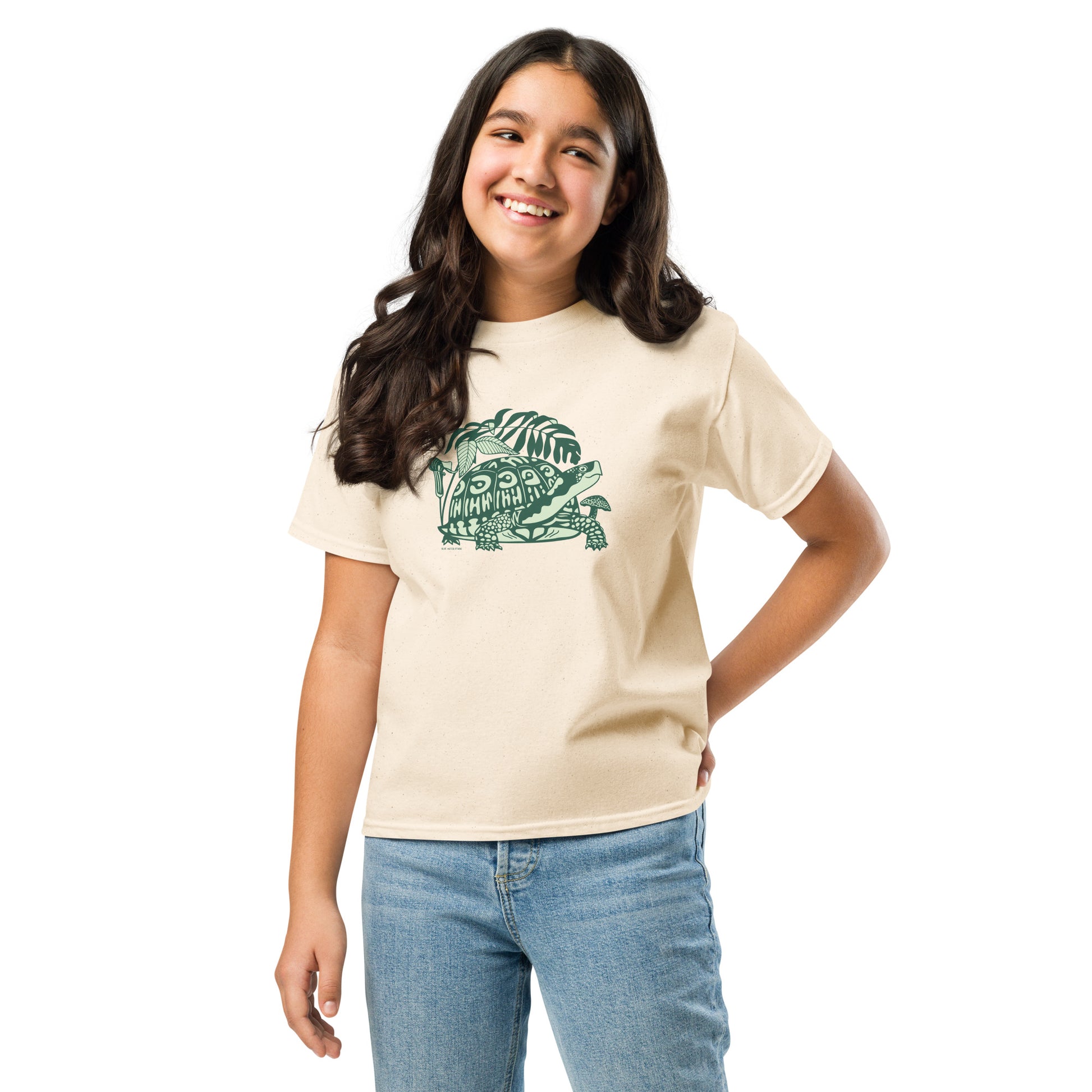 A girl wearing a box turtle t-shirt in off-white color.