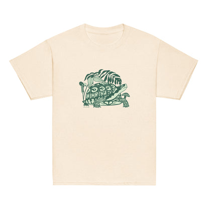 An off-white youth-sized t-shirt with a design of a happy box turtle surrounded by native North American woodland plants.