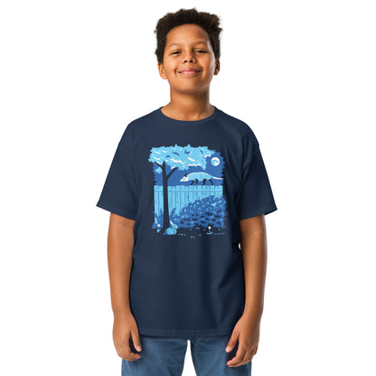 A young boy wears a navy colored t-shirt with an opossum and rabbit printed on the front.