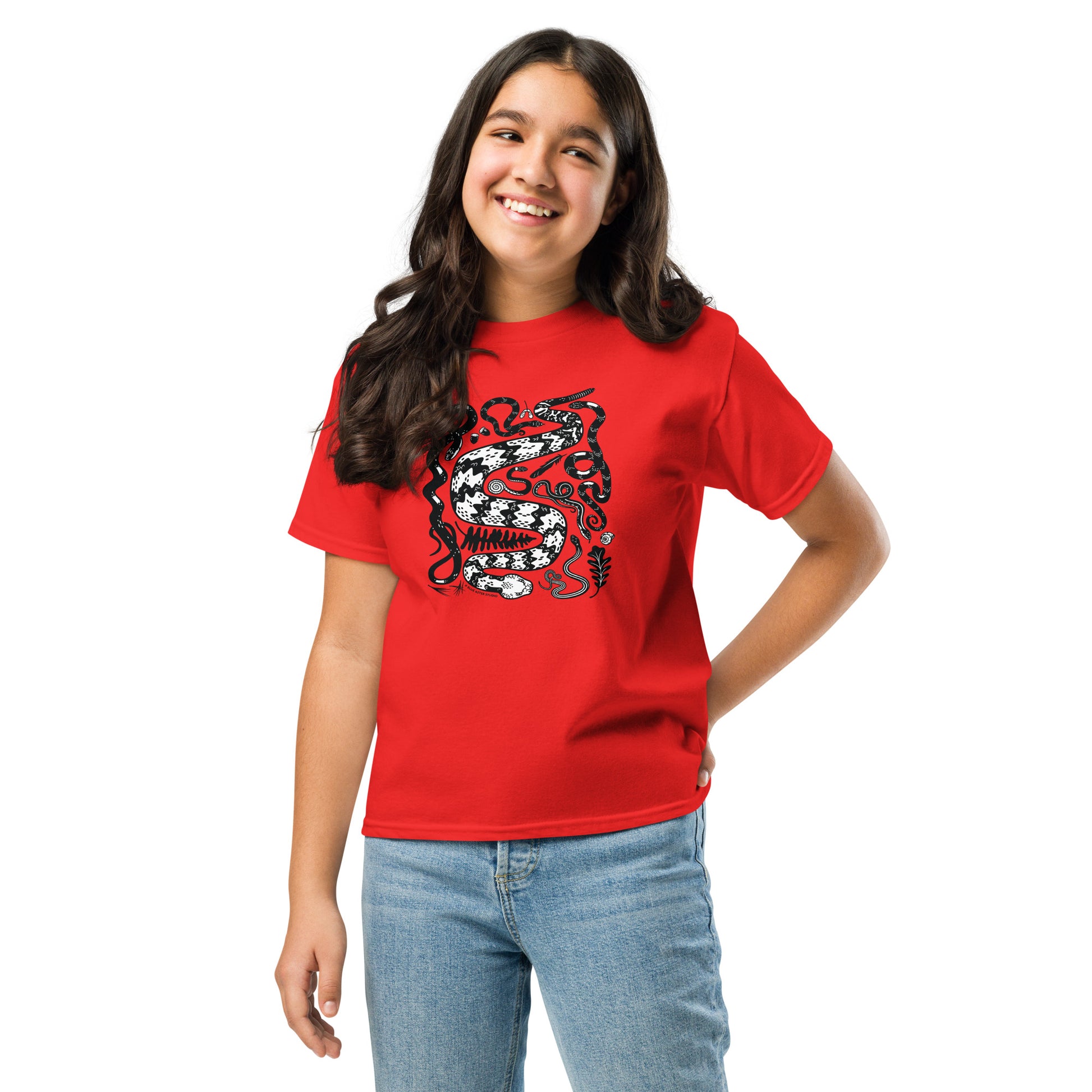 A young tween girl wearing a red seven snakes shirt.