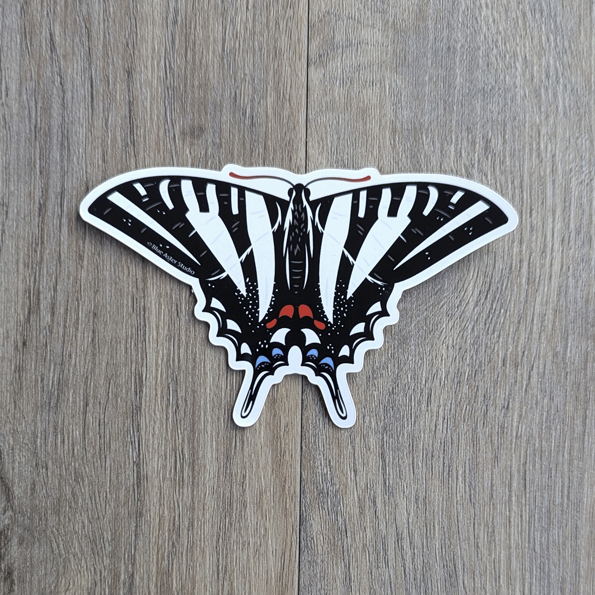 A black and white swallowtail butterfly sticker.