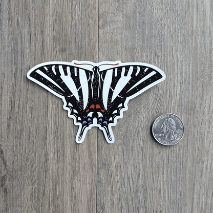 The zebra swallowtail sticker with a USD quarter coin for scale.
