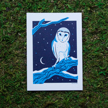 Load image into Gallery viewer, An art print of a barn owl perched on a snowy tree branch with a moon and stars in the background
