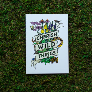 An art print of illustrated flora and fauna of the prairie wrapped in a ribbon that reads "Cherish Wild Things."