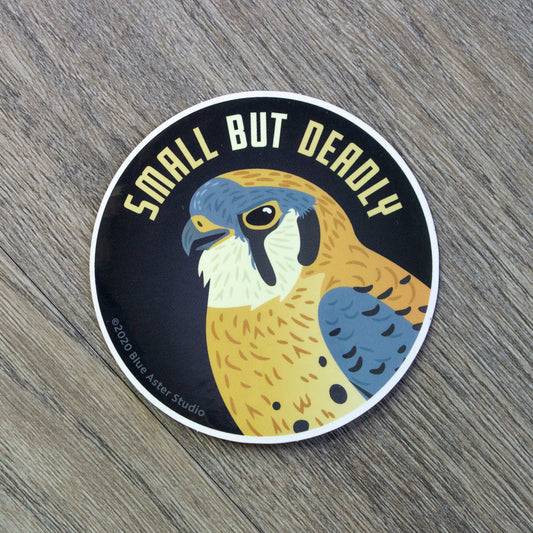 A round vinyl sticker with an illustration of an American Kestrel and the words "Small But Deadly"